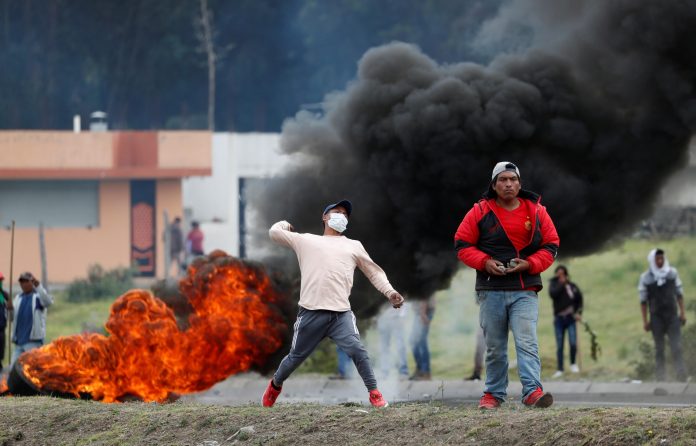 Ecuador Protest A protester aims to throw as people block a road amid clashes with soldiers during a demonstration after Ecuador’s President Lenin Moreno’s government ended the four-decade-old fuel subsidies in Lasso, Ecuador on Oct. 6. REUTERS/CARLOS GARCIA RAWLINS