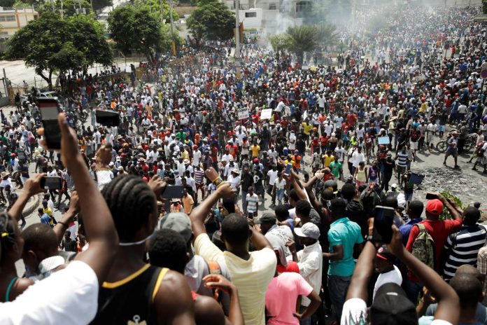 Haiti Protest People take pictures with their cellphones as protesters march to demand the resignation of Haitian president Jovenel Moise on the streets of Port-au-Prince, Haiti on Oct. 4. REUTERS/ANDRES MARTINEZ CASARES
