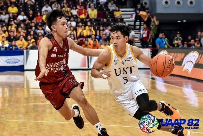 University of Santo Tomas Growling Tigers’ Henri Lorenzo Subido attacks a University of the Philippines Fighting Maroons defender. UAAP PHOTO