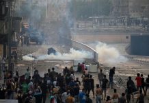 Demonstrators disperse as Iraqi security forces use tear gas during a protest in Baghdad, Iraq on Oct. 2. REUTERS/THAIER AL-SUDANI