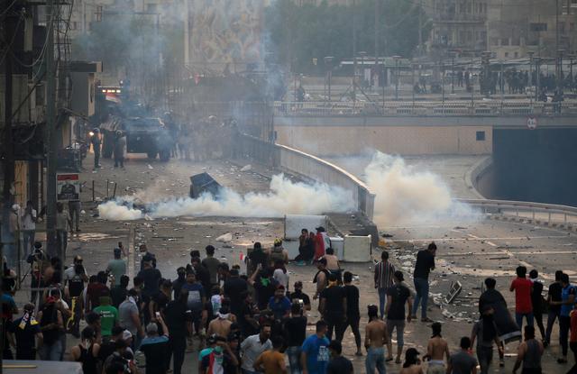 Iraq declares curfews as gunfights rage Demonstrators disperse as Iraqi security forces use tear gas during a protest in Baghdad, Iraq on Oct. 2. REUTERS/THAIER AL-SUDANI