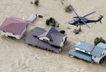 At least 23 killed in Japan typhoon An aerial view shows a Japan Self-Defense Force helicopter flying over residential areas flooded by the Chikuma river following Typhoon Hagibis in Nagano, central Japan on Oct. 13 in this photo taken by Kyodo. MANDATORY CREDIT KYODO/VIA REUTERS