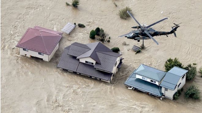 Japan Self-Defense Force helicopter An aerial view shows a Japan Self-Defense Force helicopter flying over residential areas flooded by the Chikuma river following Typhoon Hagibis in Nagano, central Japan on Oct. 13 in this photo taken by Kyodo. MANDATORY CREDIT KYODO/VIA REUTERS