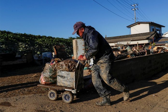 Japan Typhoon A man cleans debris in the aftermath of Typhoon Hagibis in Yanagawamachi district, Date City, Fukushima prefecture, Japan Oct. 16. SOE ZEYA TUN/REUTERS