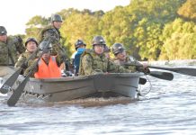 Government personnel paddle a boat during rescue operations after a typhoon swept through Kawagoe, Saitama prefecture, Japan on Oct. 13. JGSDF/VIA REUTERS
