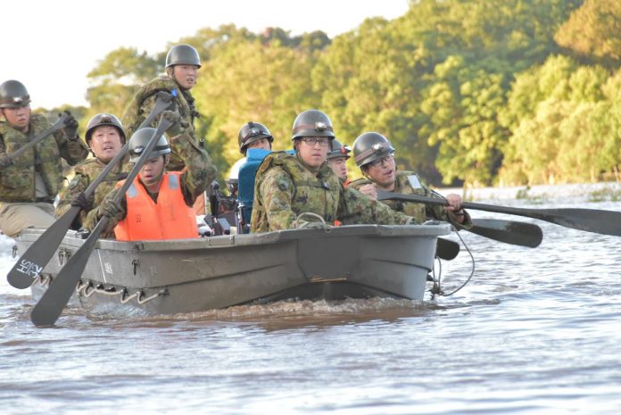 Japan Typhoon Government personnel paddle a boat during rescue operations after a typhoon swept through Kawagoe, Saitama prefecture, Japan on Oct. 13. JGSDF/VIA REUTERS