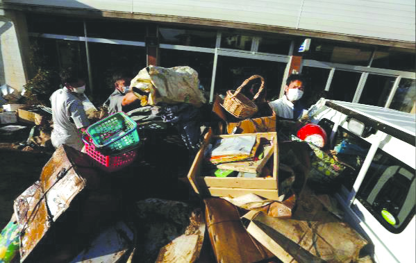 People packs items on a back of a truck, in the aftermath of Typhoon Hagibis , in Yanagawamachi district, Date City, Fukushima prefecture, Japan, Oct. 15. REUTERS
