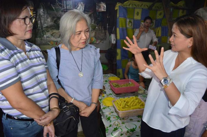Iloilo City Lone District representative Julienne “Jamjam” Baronda (right) shares to Department of Trade and Industry 6 regional director Rebecca Rascon (center) the needs of the residents in Brgy. Baldoza, La Paz, Iloilo City. Some of the residents produce and supply native delicacies like fried lumpia, suman, and puto lanson to several store outlets in the metropolis and nearby areas.