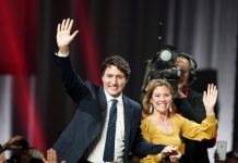 Liberal leader and Canadian Prime Minister Justin Trudeau and his wife Sophie Gregoire Trudeau wave to supporters after the federal election at the Palais des Congres in Montreal, Quebec, Canada on Oct. 22. REUTERS/CARLO ALLEGRI
