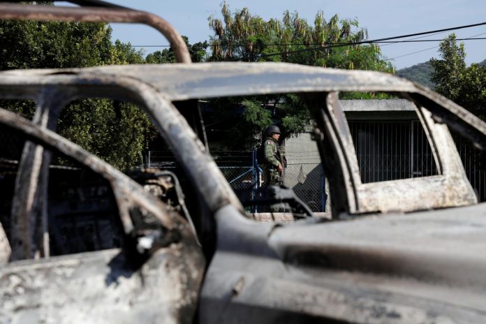 Mexico Ambush A soldier is seen near the burnt wreckage of a patrol car after an ambush by suspected cartel on police officers in El Aguaje, Michoacan state, Mexico on Oct. 14. REUTERS/ALAN ORTEGA