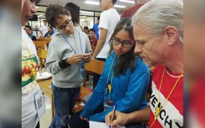 Nine-year-old Allen Blauuw (2nd from left) participates in a team activity during the National Aeronautics and Space Administration space apps challenge at the Central Philippine University on Friday. GAIL MOMBLAN/PNA