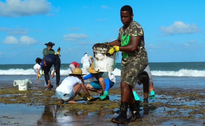 Oil spill pollutes Brazilian waters A man works to remove an oil spill on Muro Alto beach in Tamandaré, Pernambuco, Brazil. REUTERS