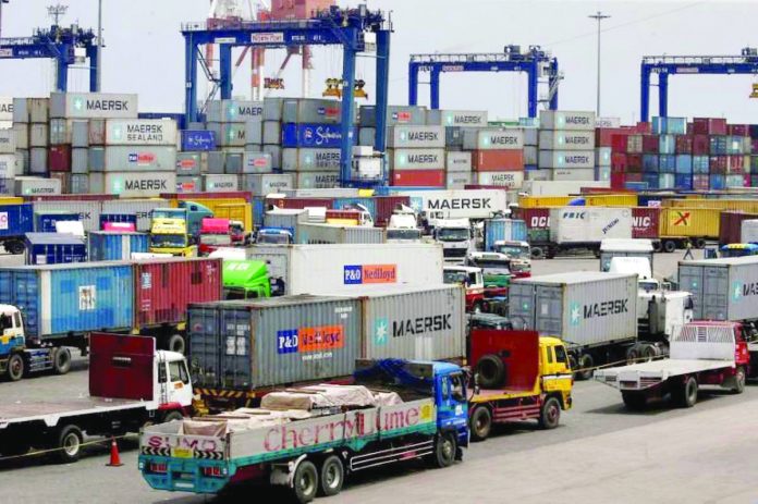 FILE PHOTO: Trucks transporting containers with imported items are prepared to leave a port in Manila Trucks transporting containers with imported items are prepared to leave a port in Manila. REUTERS