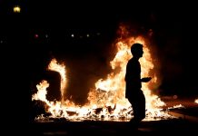 Protest sets Barcelona streets on fire A demonstrator walks past a fire during a protest in Barcelona, Spain on Oct. 16. REUTERS/ALBERT GEA
