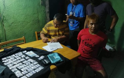 Drug suspect Rene Tobongbanua (seated on the right) was arrested in an entrapment operation in Barangay Mansilingan, Bacolod City on Oct. 16. BACOLOD CITY POLICE OFFICE STATION