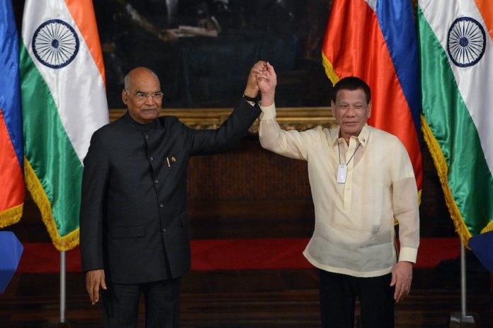 Philippine President Rodrigo Duterte and Indian counterpart Ram Nath Kovind raise each other’s hands after attending a joint press conference in Malacañang Palace in Manila on Oct. 18. TED ALLJIBE/AFP