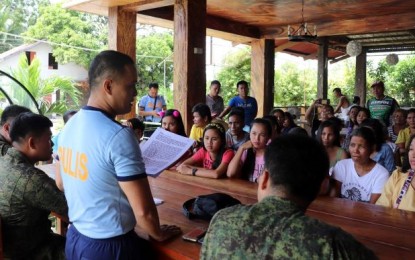 Sagay City police station chief Major Antonio Benitez Jr. Sagay City police station chief Major Antonio Benitez Jr. (standing) with officers of the Philippine Army’s 79th Infantry Battalion meets with the families of the “Sagay 9” victims on Oct. 20. 79IB/Philippine Army