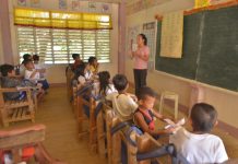 Wanted: 500 remedial reading teachers to help nonreaders Combined Grade 2 and Grade 3 pupils listen attentively to their teacher Flordeluna Monares.