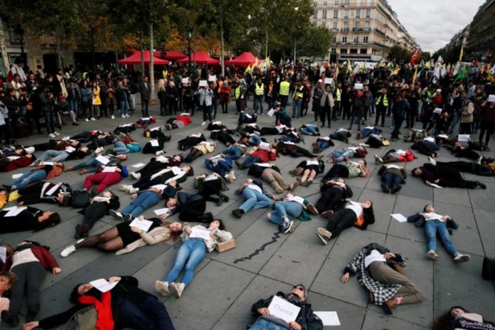 People stage a “die-in” at Place de la Republique during a demonstration against domestic violence in Paris, France on Oct. 19. REUTERS/BENOIT TESSIER