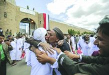 A Yemeni detainee is greeted by his relative and friends after his release from a prison controlled by Houthi rebels, in Sanaa, Yemen on Sept. 30, 2019. AP