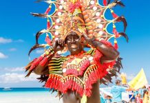 Man in a colorful headdress during the Ati-Atihan celebration in Boracay Island, Malay, Aklan. The Kalibo Santo Niño Ati-Atihan Management Council Incorporated is eyeing to revive the classic 1980s favorite – the snake dancing tradition in the capital town. FROLOVA_ELENA/ SHUTTERSTOCK