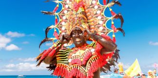 Man in a colorful headdress during the Ati-Atihan celebration in Boracay Island, Malay, Aklan. The Kalibo Santo Niño Ati-Atihan Management Council Incorporated is eyeing to revive the classic 1980s favorite – the snake dancing tradition in the capital town. FROLOVA_ELENA/ SHUTTERSTOCK