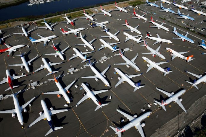 Dozens of grounded Boeing 737 MAX aircraft are seen parked at Boeing Field in Seattle, Washington, United States. Boeing on Monday said it expects the 737 MAX airplane, which was grounded after two crashes killed 346 people, to resume flying in January, delaying its return by a month. LINDSEY WASSON/REUTERS