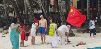 There photos that went viral on social media over the week show an unidentified tourist planting a Chinese flag in the sands of world-famous Boracay Island in Malay, Aklan. The island’s inter agency task force says it will launch a probe into the motive of the tourist. CONTRIBUTED PHOTO