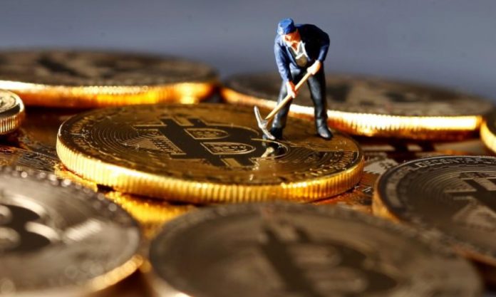 Crypto-currencies A small toy figure is seen on representations of the Bitcoin virtual currency in this illustration picture, Dec. 26, 2017. DADO RUVIC/REUTERS