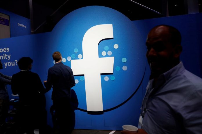 Attendees walk past a Facebook logo during Facebook Inc.’s F8 developers’ conference in California, United States. STEPHEN LAM/REUTERS