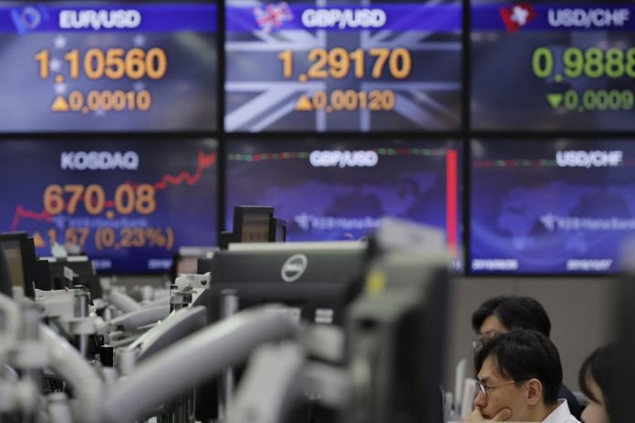 Global shares A currency trader gazes at computer monitors near screens showing the foreign exchange rates at the foreign exchange dealing room in Seoul, South Korea, Nov. 18. Asian shares are mixed Monday in a cautious mode after Wall Street closed out the week with milestones as the Dow Jones Industrial Average crossed 28,000 for the first time and the S&P 500 and Nasdaq hit record highs. LEE JIN-MAN/AP
