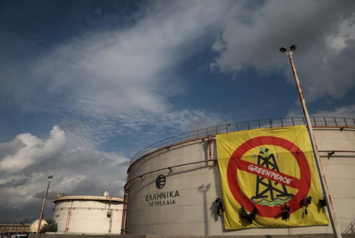 Greenpeace activists Greenpeace activists hang from an oil tank at the Hellenic Petroleum refineries in Aspropyrgos near Athens, Greece, on Nov. 21. COSTAS BALTAS/REUTERS