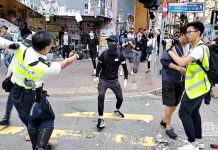 HK police officer shoots protester A still image from a social media video shows a police officer aiming his gun at a protester in Sai Wan Ho, Hong Kong, China on Nov. 11. CUPID PRODUCER VIA REUTERS