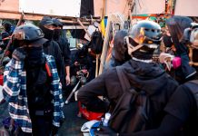 Hong Kong to shut schools amid protests Anti-government protesters scout at a makeshift gate during a standoff with riot police at a university in Hong Kong, China on Nov. 14. REUTERS/TYRONE SIU