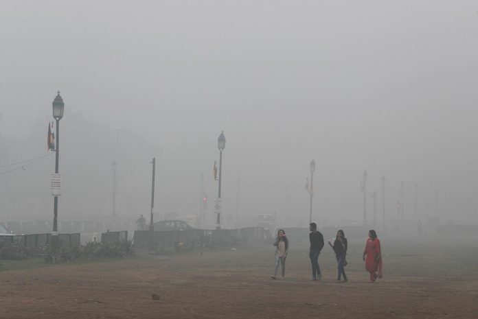 Indian capital banishes some cars amid pollution People walk on a smoggy morning in New Delhi, India on Nov. 3. REUTERS/ADNAN ABIDI