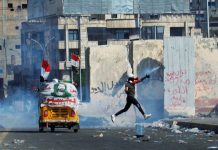 Iraqis pour into streets for protest A demonstrator throws away a tear gas canister during an anti-government protest in Baghdad, Iraq on Nov. 1. REUTERS/KHALID AL-MOUSILY
