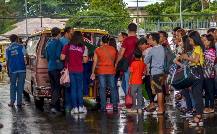 Jeepneys Passengers wait for their turn to board this jeepney in Barangay Buhang, Jaro, Iloilo City. The jeepney is the core of Philippine public transport. It started as remodeled army vehicles left behind by US forces after World War II. IAN PAUL CORDERO/PN