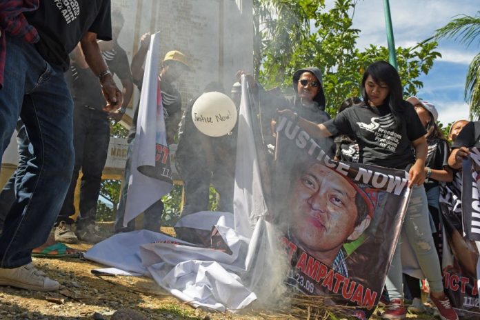 Maguindanao massacre Children and relatives of the 32 journalists killed in the 2009 massacre burn giant tarps with photos of the Ampatuan clan, the political family tagged in the killings, during a visit at the massacre site in Masalay, Ampatuan town, Maguindanao last year. FROILAN GALLARDO/ABS-CBN NEWS