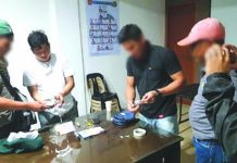 Antidrug operatives inspect the seized sachets of suspect shabu from Mark Andrew Panganiban (2nd from the left). PDEA REGION 6