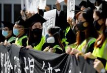 Masked univ students rally at grad rites in HK Graduates wearing masks hold an anti-government rally after their graduation ceremony at a university in Hong Kong, China on Nov. 7. REUTERS/KIM KYUNG-HOON