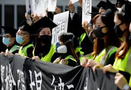 Graduates wearing masks hold an anti-government rally after their graduation ceremony at a university in Hong Kong, China on Nov. 7. REUTERS/KIM KYUNG-HOON