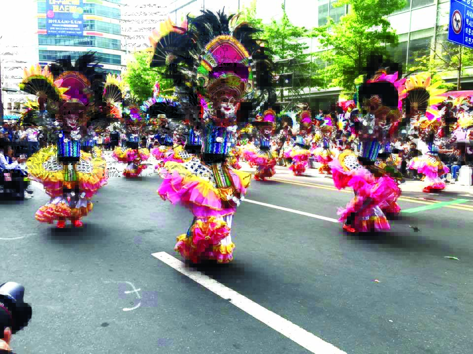 Wearing flamboyant costumes and ever-smiling masks, these dancers show off their signature MassKara routine during the 2019 Daegu Colorful Festival in Daegu City, South Korea on May 5, 2019.