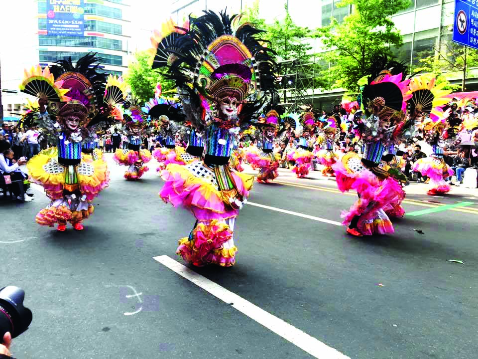 Wearing flamboyant costumes and ever-smiling masks, these dancers show off their signature MassKara routine during the 2019 Daegu Colorful Festival in Daegu City, South Korea on May 5, 2019. 