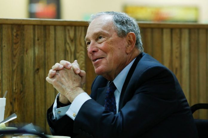 Michael Bloomberg, the billionaire media mogul and former New York City mayor, eats lunch with Little Rock mayor Frank Scott, Jr. after adding his name to the Democratic primary ballot in Little Rock, Arkansas, United States, Nov. 12.