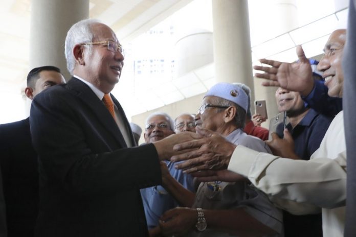 Najib Razak Former Malaysian prime minister Najib Razak, left, greets supporters as he arrives at Kuala Lumpur High Court in Kuala Lumpur, Malaysia, Nov. 11. An important court ruling Monday in the first corruption trial of Najib will be a test of the legal system and of the credibility of the prime minister who brought about his shocking ouster from office last year. VINCENT THIAN/AP