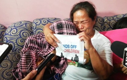 Nilda Villamonte Nilda Villamonte of La Carlota City, Negros Occidental tightly embraces her 12-year-old daughter after they were reunited in Bacolod City on Saturday. The girl, whom she thought was attending a dance practice, was among the 14 minors arrested by authorities during a raid in Barangay Bata on Thursday. NANETTE L. GUADALQUIVER/PNA