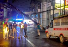 A pole of Panay Electric Co. dangerously leans in Jaro, Iloilo City. A passing container van hit a dangling cable on Wednesday night, Nov. 13, 2019, inadvertently dragging the pole, according to witnesses. IAN PAUL CORDERO/PN