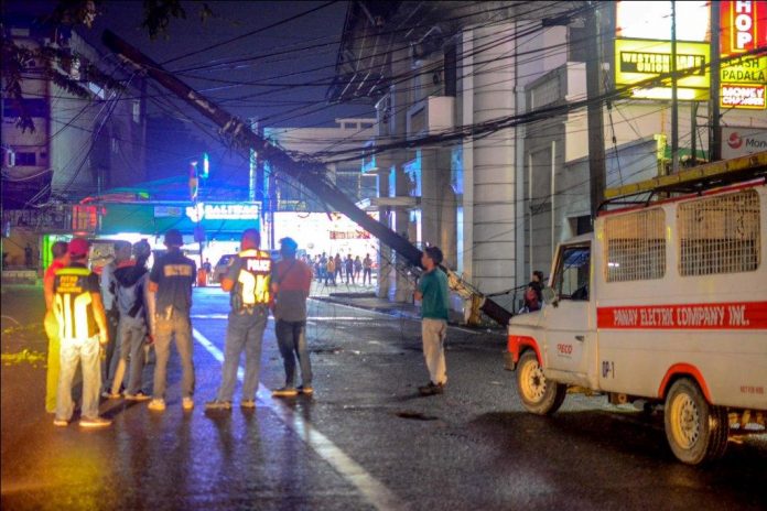 A pole of Panay Electric Co. dangerously leans in Jaro, Iloilo City. A passing container van hit a dangling cable on Wednesday night, Nov. 13, 2019, inadvertently dragging the pole, according to witnesses. IAN PAUL CORDERO/PN