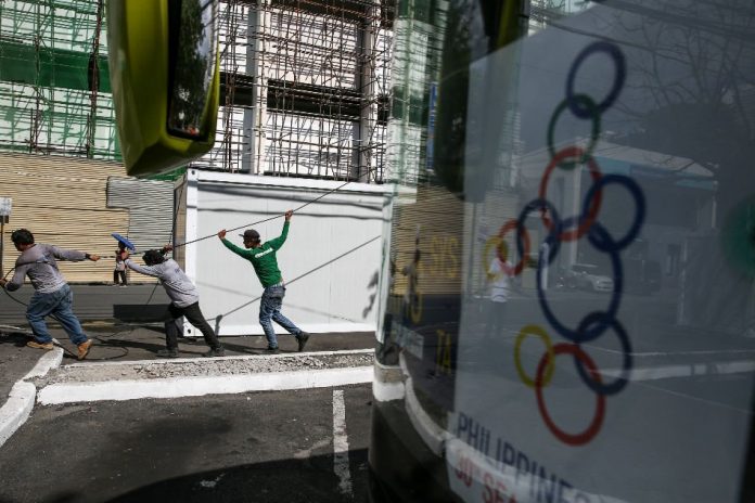 SEA Games woes Workers tug on telecommunication cables near the Philippine Wushu Building which is ongoing construction near the Rizal Memorial Coliseum in Manila in Nov. 27, 2019. ABS-CBN NEWS
