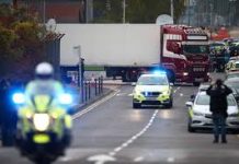 Second man charged over UK truck deaths Police move the lorry container where bodies were discovered in Grays, Essex, Britain on Oct. 23. REUTERS/HANNAH MCKAY